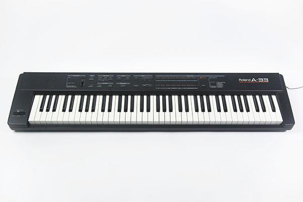 Roland a-33 synthesizer with bench stand