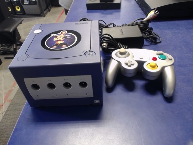 Console mauve avec manette grise +acc