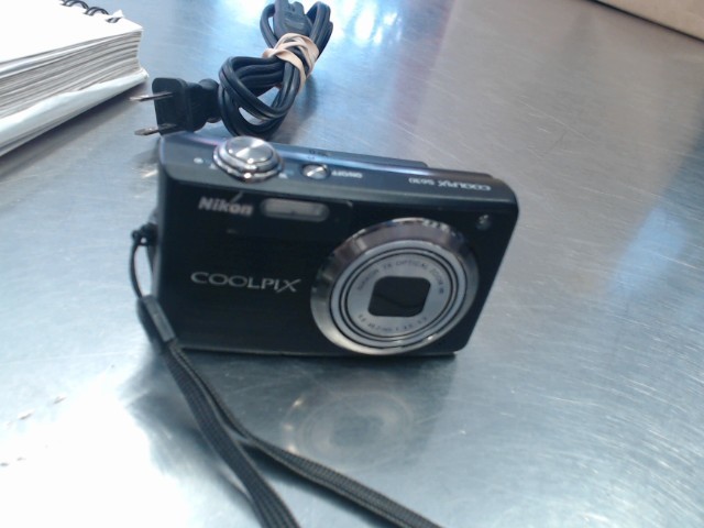 Nikon coolpix  digital camera with char.
