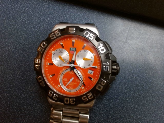 Montre argent cadrant orange avec boite